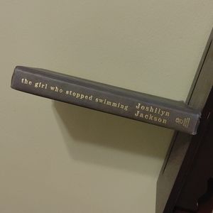 A book. 'The Girl Stopped Swimming' by Joshilyn Jackson.